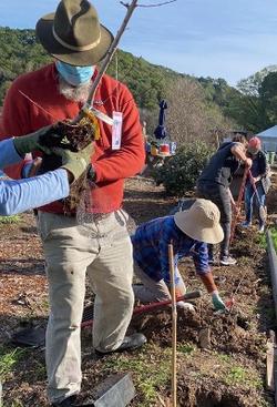 Volunteers planting at the Edible Demonstration Garden. Photo by Joan Kozlowski